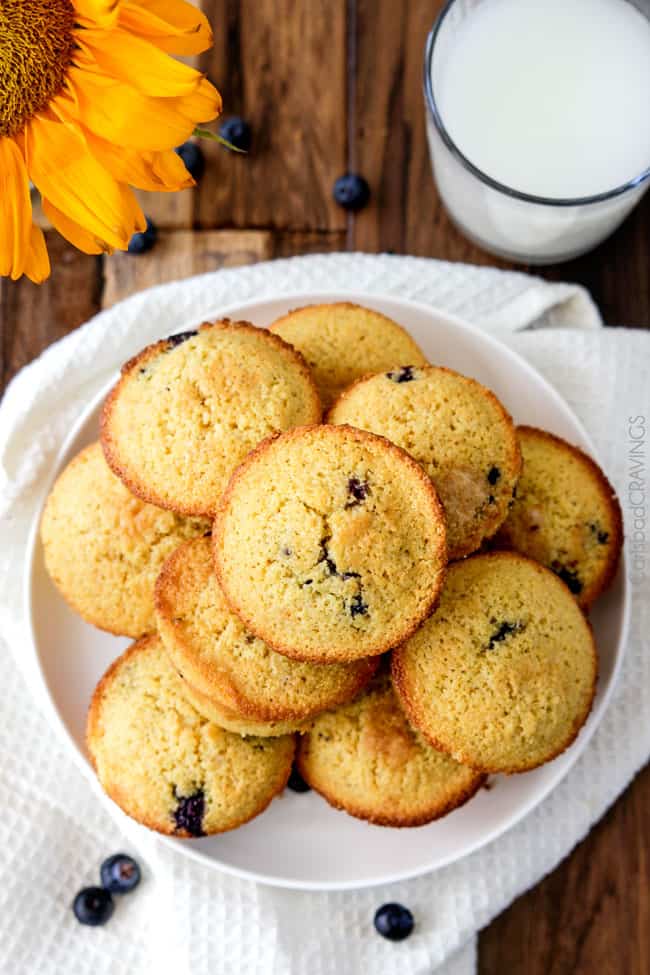 overhead view of plate piled high with blueberry cornmeal muffins