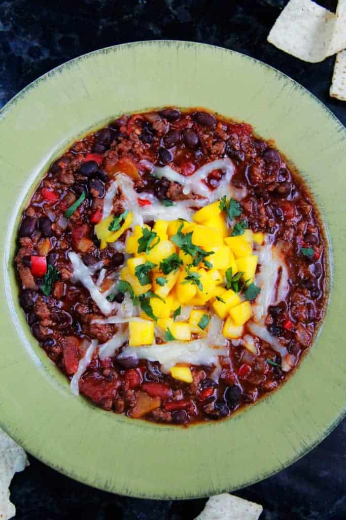 Top view of Mango Black Bean Chili in a green bowl.