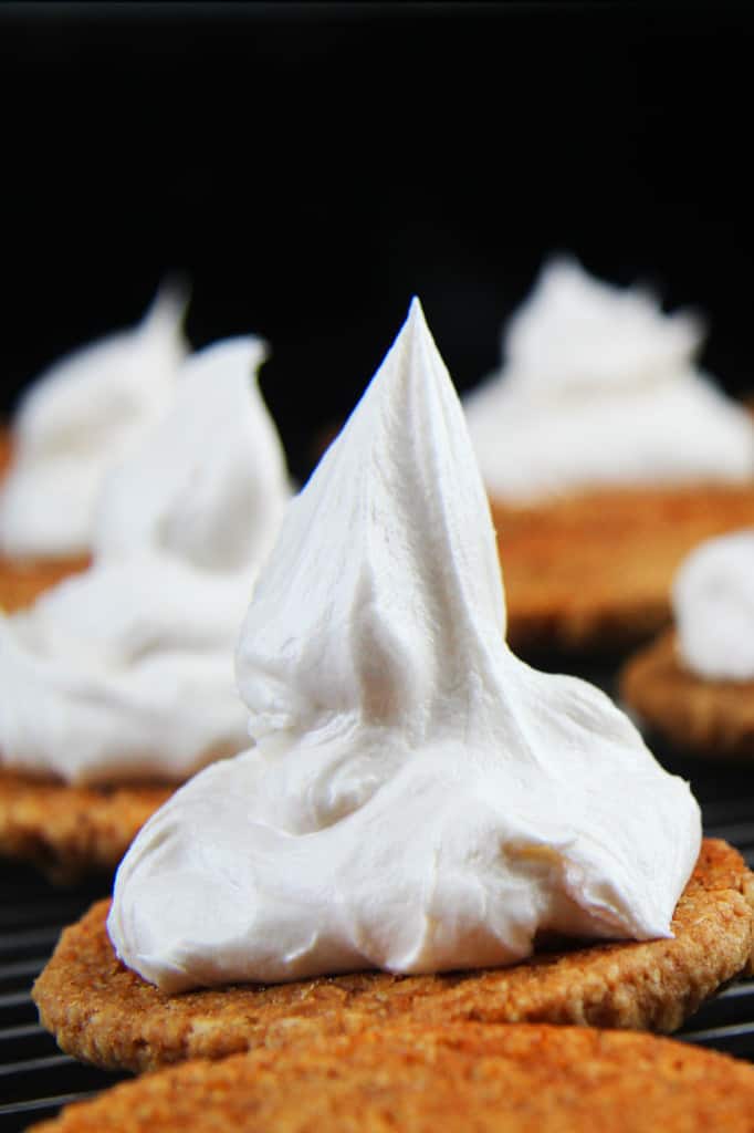 These Little Debbie's Oatmeal Cream Pies copycat are melt-in-your-mouth addicting. The cookies are bursting with buttery, chewy, brown sugar, molasses oatmeal which sand which a luscious creamy vanilla center. After one bite, you will never want to buy Little Debbies' Oatmeal Cream Pies ever again! showing how to make oatmeal cream pies by frosting bottom sides of cookies