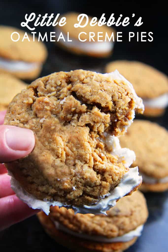 These Little Debbie's Oatmeal Cream Pies copycat are melt-in-your-mouth addicting. The cookies are bursting with buttery, chewy, brown sugar, molasses oatmeal which sand which a luscious creamy vanilla center. After one bite, you will never want to buy Little Debbies' Oatmeal Cream Pies ever again! side view of homemade oatmeal cream pies with a bite taken out of one of the cookies