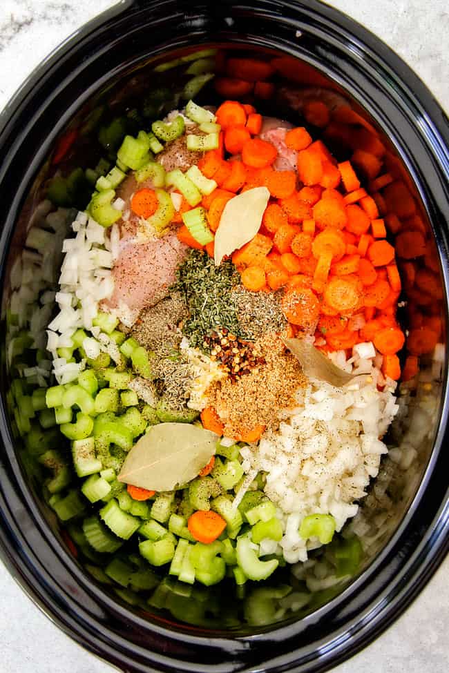 This is the BEST Slow Cooker Chicken Tortellini Soup you will ever try! It's super easy, seasoned to perfection and a comforting, satisfying dinner any night of the week! showing how to make Chicken Tortellini Soup by adding carrots, onions, celery, seasonings to a crock pot