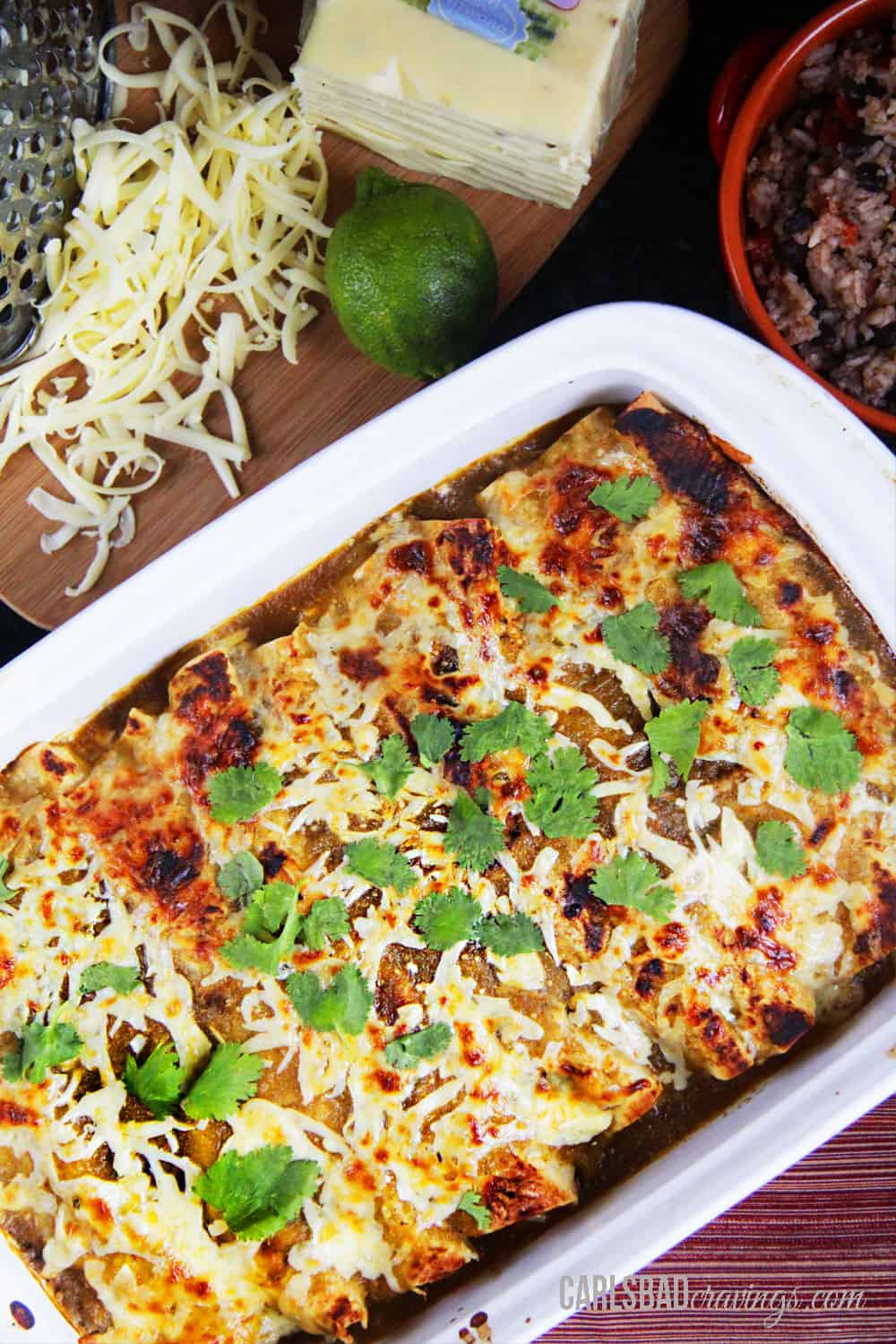 top view of salsa verde chicken enchiladas in a white baking dish