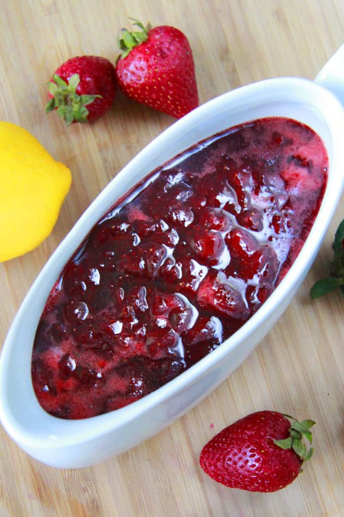 The finished Home made Strawberry Syrup in a white bowl.
