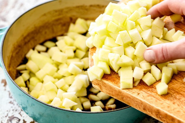 showing how to make apple syrup by adding apples to a saucepan