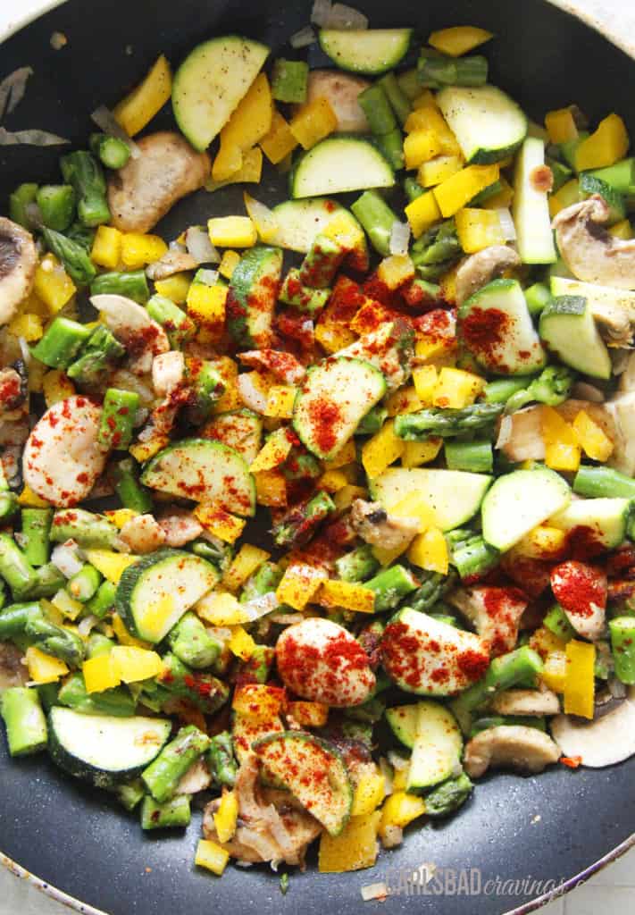 showing how to make savory crepes by cooking vegetable filling