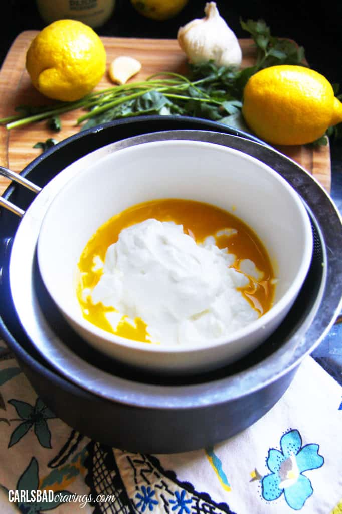 showing how to make Healthy Hollandaise Sauce recipe by adding eggs and Greek yogurt to a double broiler
