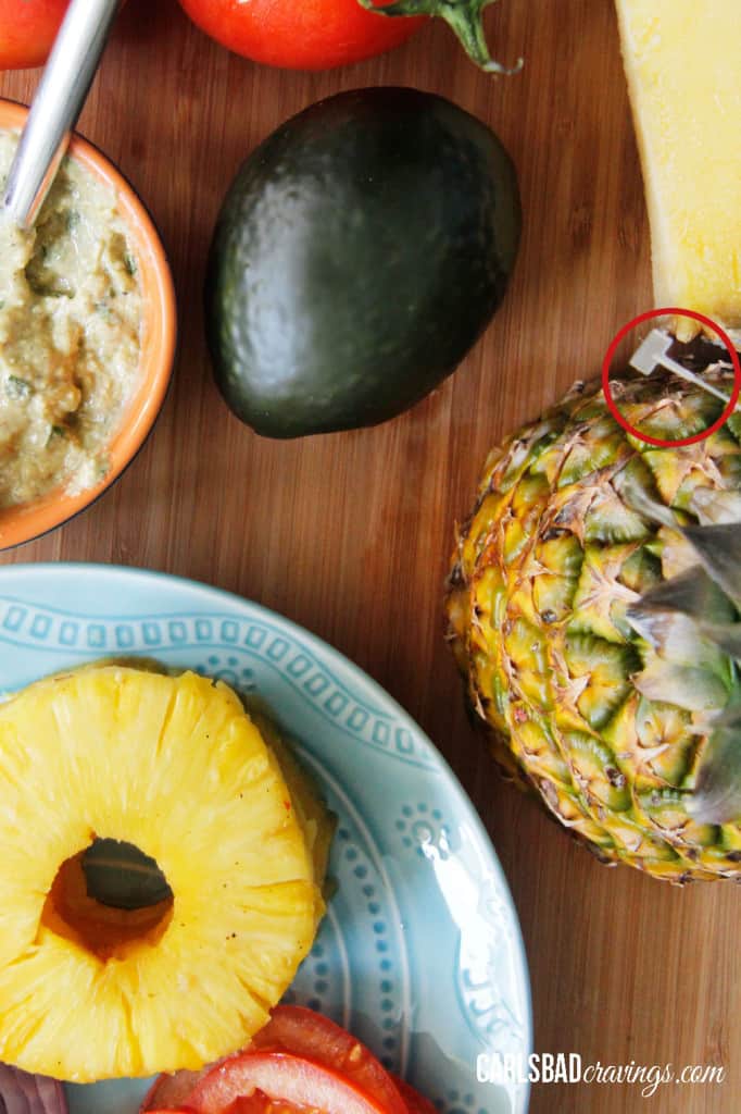 top view showing ingredients for Teriyaki Chicken Sandwiches with pineapple, tomatoes, red onions, avocados, letuce