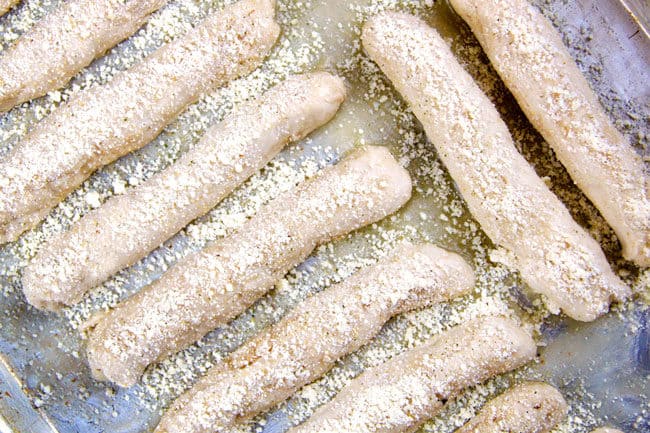 showing how to make Olive Garden Breadsticks by lining them on a baking sheet