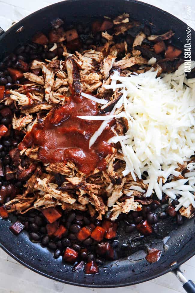 Showing how to make Chipotle Chicken Enchiladas by cooking the meat cheese and beans in a pan.