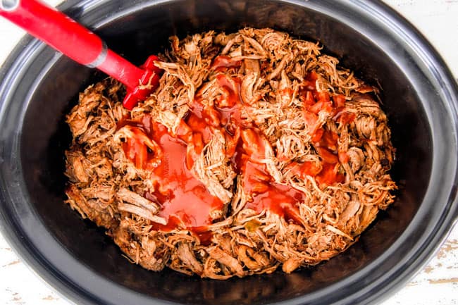adding enchilada sauce to shredded chipotle pork in crockpot to make Cafe Rio Sweet Pulled Pork