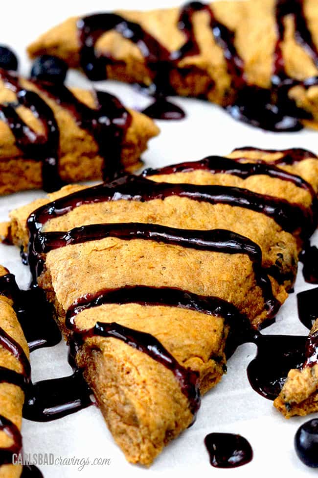 Close up view of Pumpkin Scones with a cinnamon blueberry glaze side view.