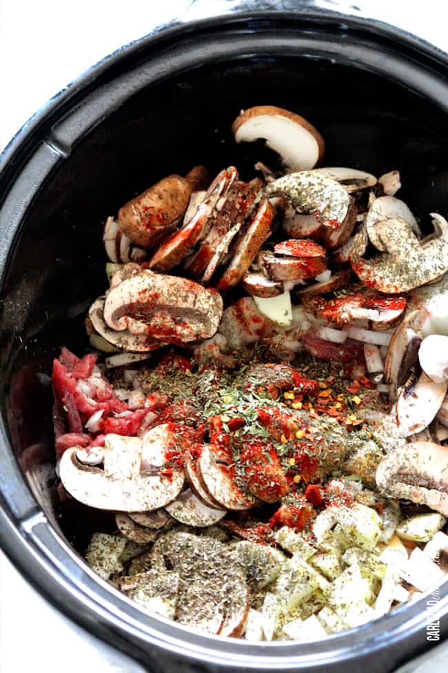Showing how to make Beef Stroganoff Soup by adding mushrooms and vegetable in the slow cooker.