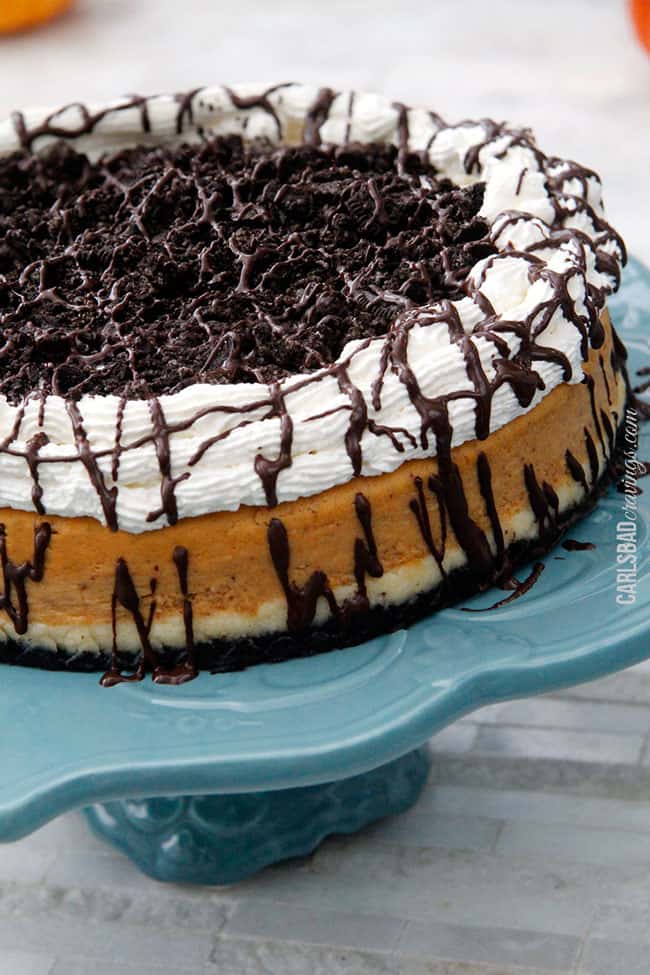 double layer pumpkin cheesecake recipe on a blue cake platter.