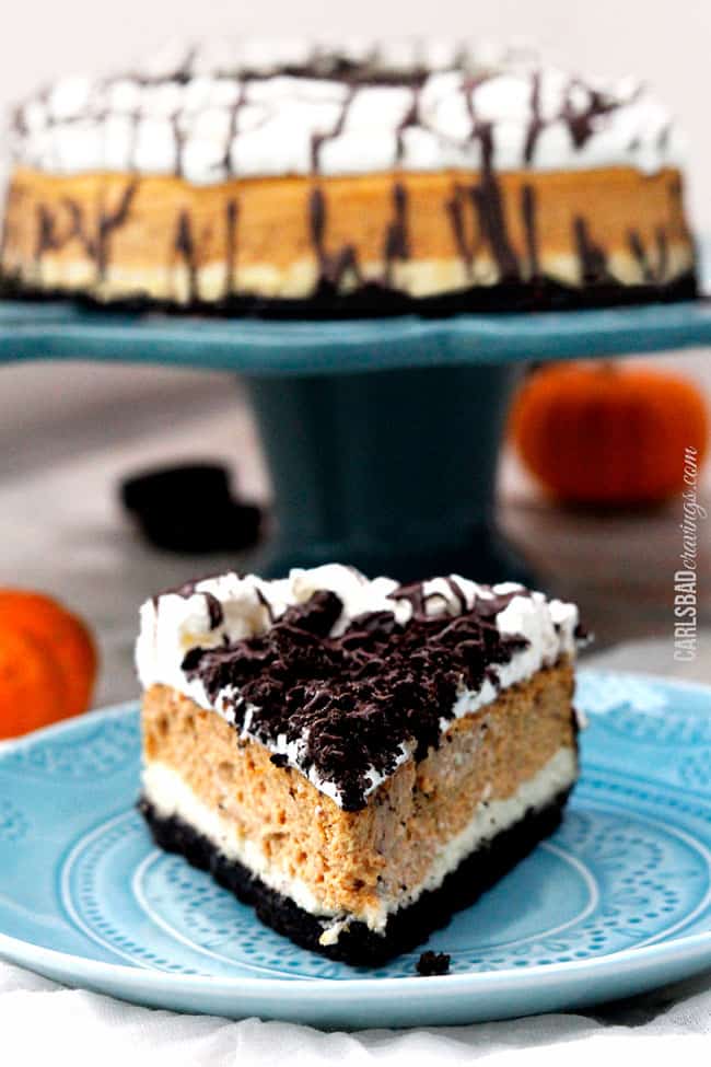 Slice of a pumpkin cheesecake on a blue serving plate.