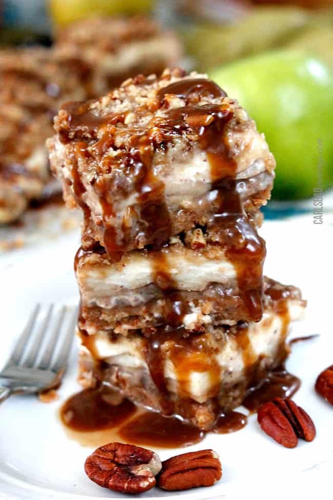 front view of Caramel Apple Cheesecake baras recipe with pecans on a white plate.