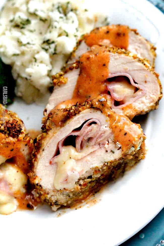 baked chicken cordon bleu recipe on a plate with chicken cordon bleu sauce