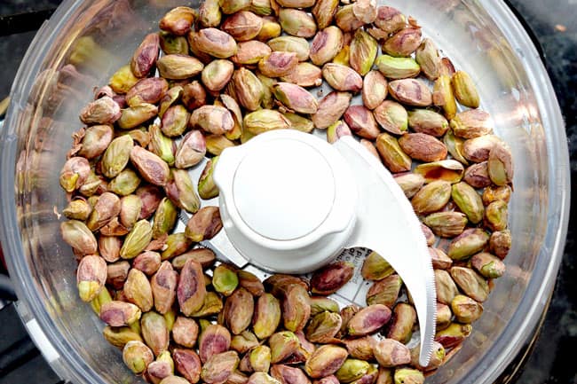 showing how to make chicken cordon bleu by adding breading ingredients to a food processor