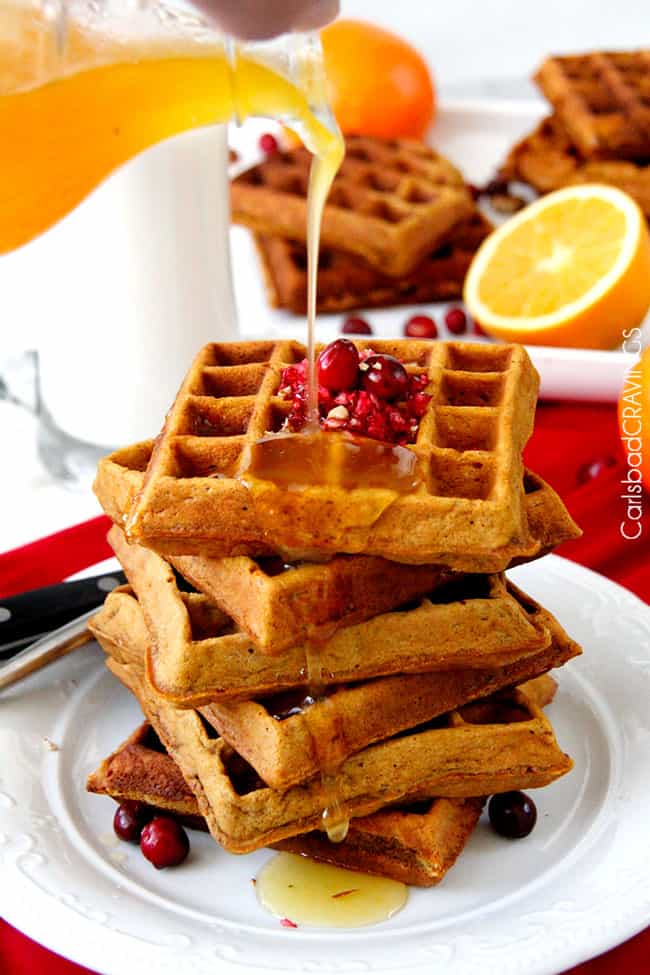 pouring syrup over a stack of Gingerbread Waffles
