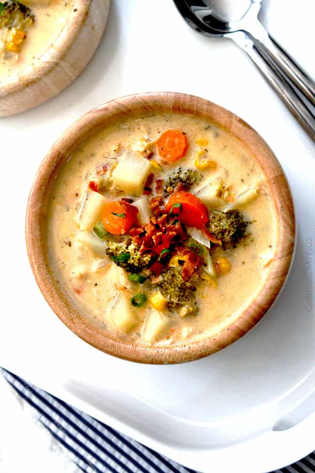 top view of a wooden bowl of crockpot corn chowder