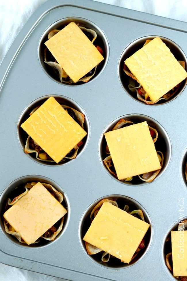 Tuna Melt Cups in muffin tin with cheese on top to be melted.