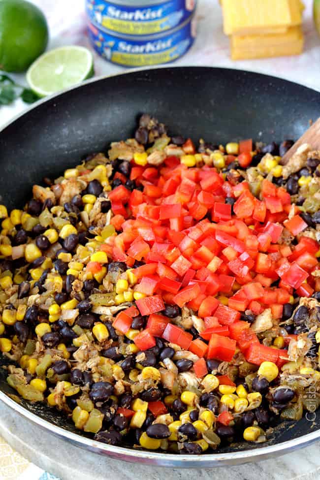 Showing how to make Tuna Melt Cups by mixing ingredients in a cooking pan.