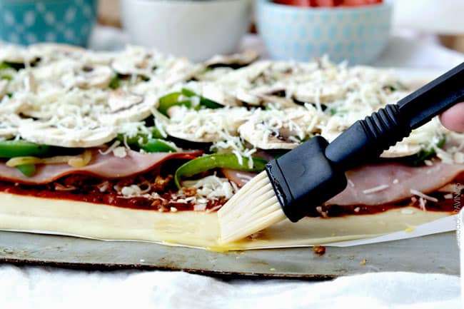 35 Minute Stromboli made with No Wait, No Rise dough! This Stromboli is easy enough for a weekday meal, delicious enough to be the "must have" appetizer at every gathering. showing how to make stromboli by spreading an egg wash over the edges