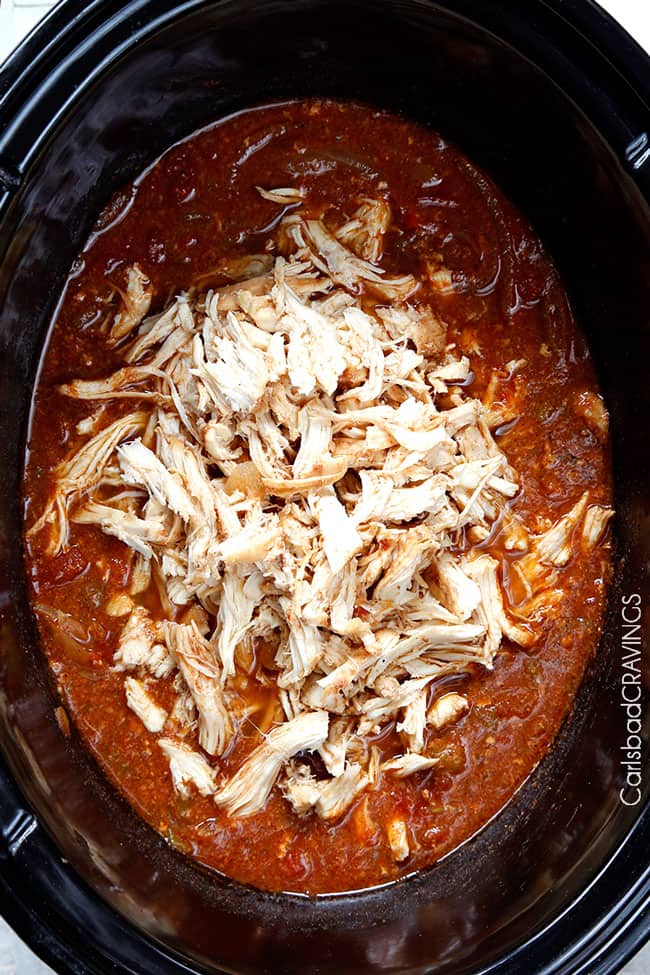 Crockpot Chicken Fajitas are the easiest way to make restaurant delicious chicken fajitas at home! Dump and simmer while you take a nap and let the citrus fiesta bath tenderize your chicken. showing how to make crockpot chicken fajitas by adding chicken to crockpot with orange juice, lime juice, green chilies, liquid smoke