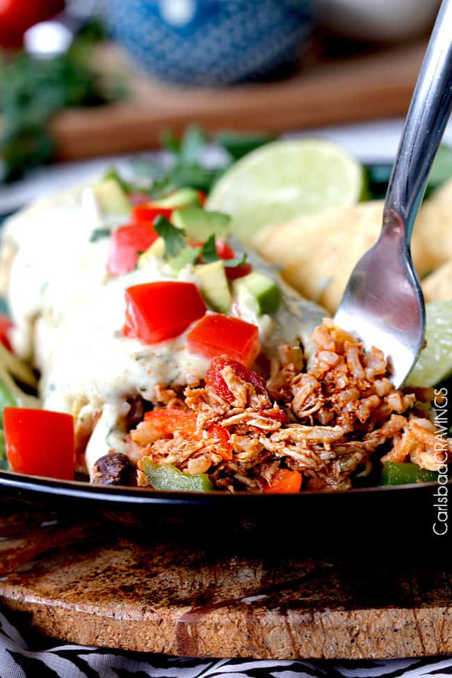 Crockpot Chicken Fajitas are the easiest way to make restaurant delicious chicken fajitas at home! Dump and simmer while you take a nap and let the citrus fiesta bath tenderize your chicken. crockpot chicken fajitas wrapped in a tortilla on a plate with chips and limes