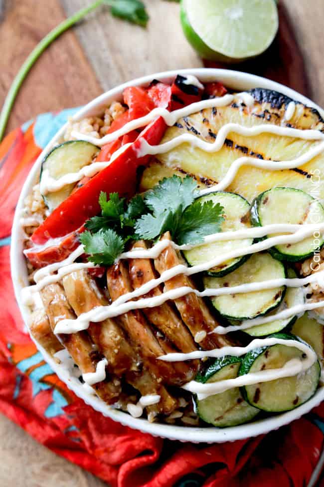 overhead view of grilled teriyaki chicken bowl drizzled with crema