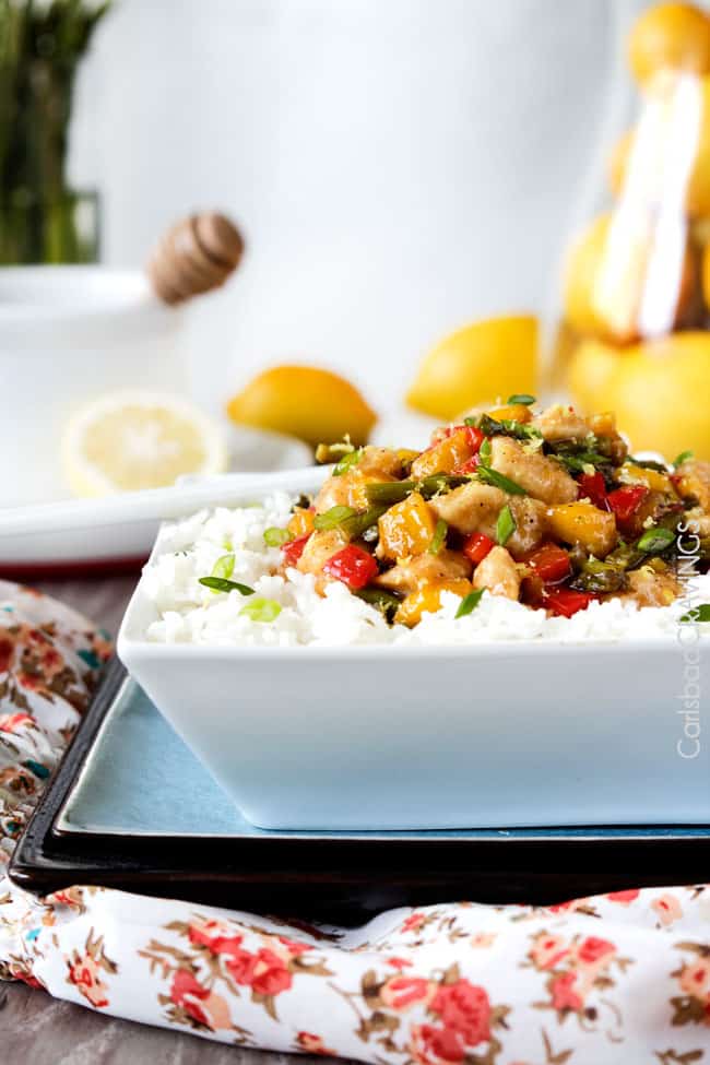 Close up view of Honey Lemon Chicken Stir Fry over white rice in a bowl.