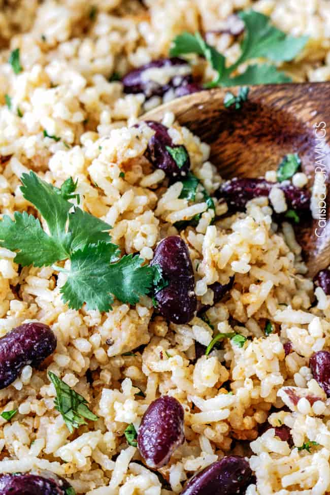 Extreme close up of Red Beans and Rice with a serving spoon and cilantro on top.