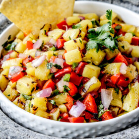Sweet and smoky Grilled Pineapple salsa with not only grilled pineapple but GRILLED red bell peppers, red onions AND jalapeno! sweet and smoky and possibly the best salsa E-V-E-R alone, with chips, tacos or on fish/chicken. #pineapple #salsa #pineapplesalsa #grill