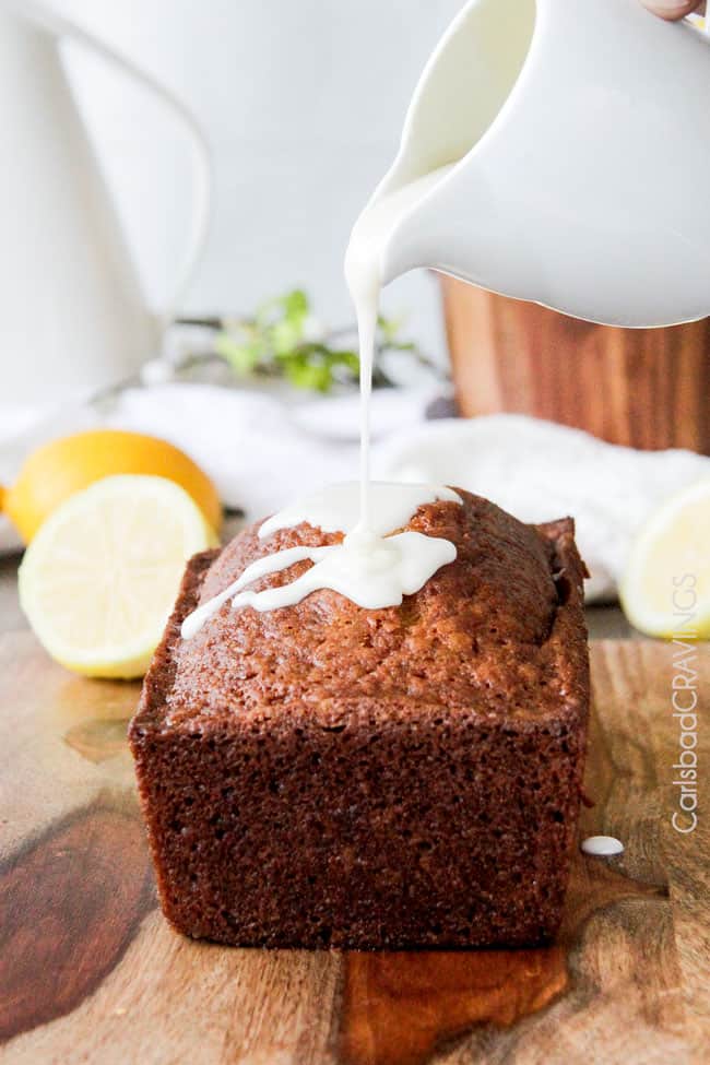 showing how to make lemon bread by pouring lemon cream cheese glaze on top