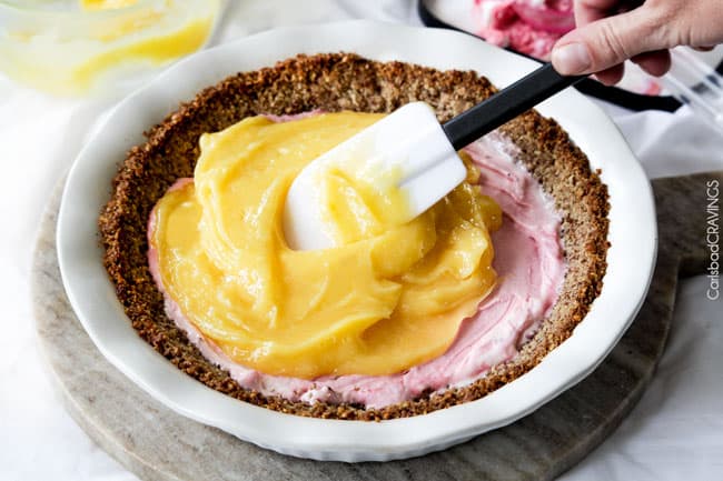 Showing how to make Frozen Lemon Meringue Pie by adding the lemon filling in the pie crust.