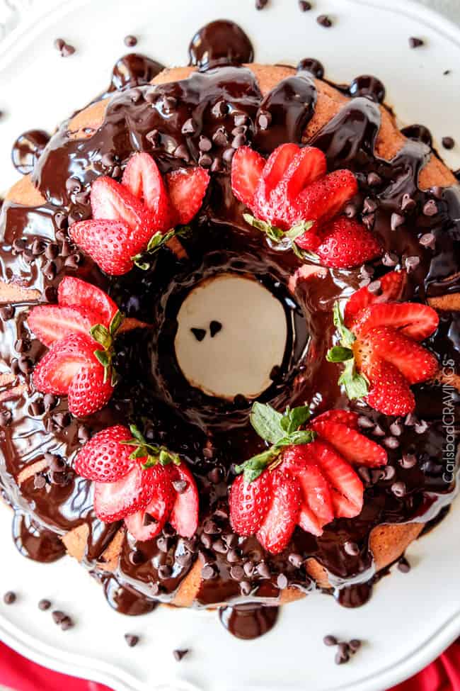 5 Minute Fool Proof Chocolate Ganache (sauce) is silky, creamy, sweet and 1,000 TIMES BETTER than any store bought chocolate sauce. Perfect for brownies, ice cream, cakes, popcorn, strawberries, etc top view of a cake covered with chocolate ganache glaze
