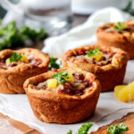 EASY Mini Deep Dish Hawaiian Pizzas baked in premade crescent dinner rolls for an easy buttery, fluffy crust and stuffed with your favorite Hawaiian pizza toppings smothered in a barbecue marinara. Fabulous appetizers or fun family meal and totally customizable - the possibilities are endless! #pizza #Hawaiian #Hawaiianpizza #mini