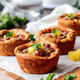 EASY Mini Deep Dish Hawaiian Pizzas baked in premade crescent dinner rolls for an easy buttery, fluffy crust and stuffed with your favorite Hawaiian pizza toppings smothered in a barbecue marinara. Fabulous appetizers or fun family meal and totally customizable - the possibilities are endless! #pizza #Hawaiian #Hawaiianpizza #mini