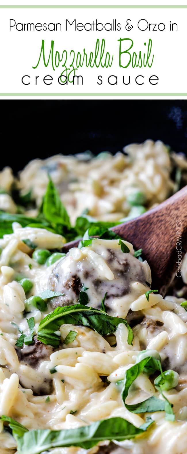 Parmesan Meatballs in a cream sauce with orzo and basil being served with a wood spoon.