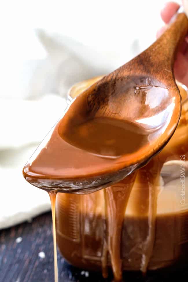 Close up of Coconut Caramel Sauce dripping off a spoon.
