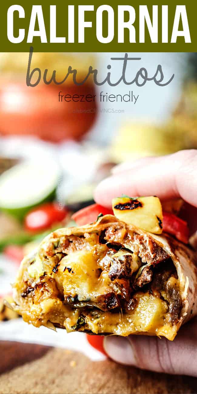 up close of a hand holding a California Burrito with french fries, carne asada, sour cream and guacamole 