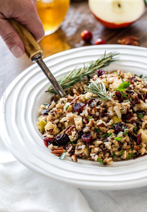 Easy one pot Cranberry Apple Pecan Rice Pilaf simmered in herb seasoned chicken broth and apple juice and riddled with sweet dried cranberries, apples and roasted pecans for an unbelievable savory sweet side dish perfect for the holidays. Everyone always asks for this recipe!