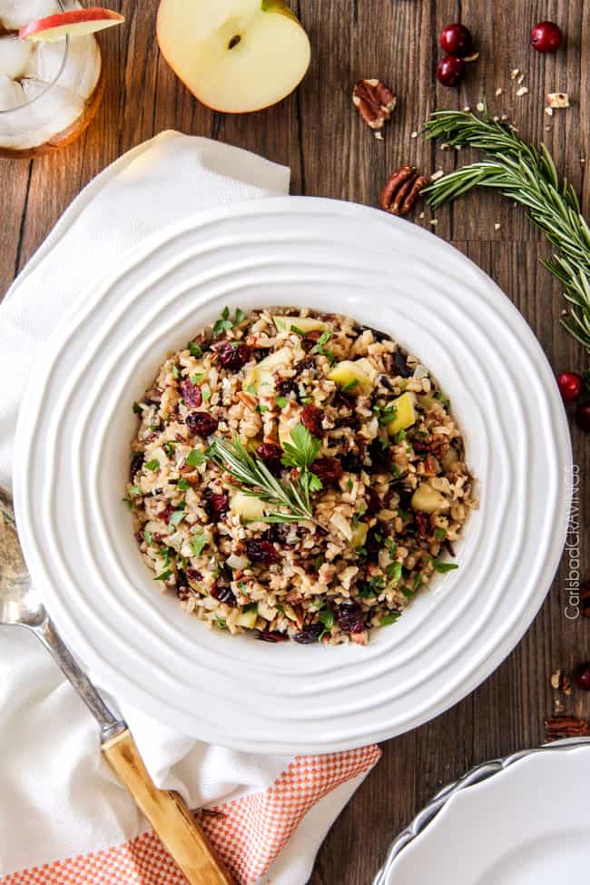 Easy one pot Cranberry Apple Pecan Rice Pilaf simmered in herb seasoned chicken broth and apple juice and riddled with sweet dried cranberries, apples and roasted pecans for an unbelievable savory sweet side dish perfect for the holidays. Everyone always asks for this recipe!