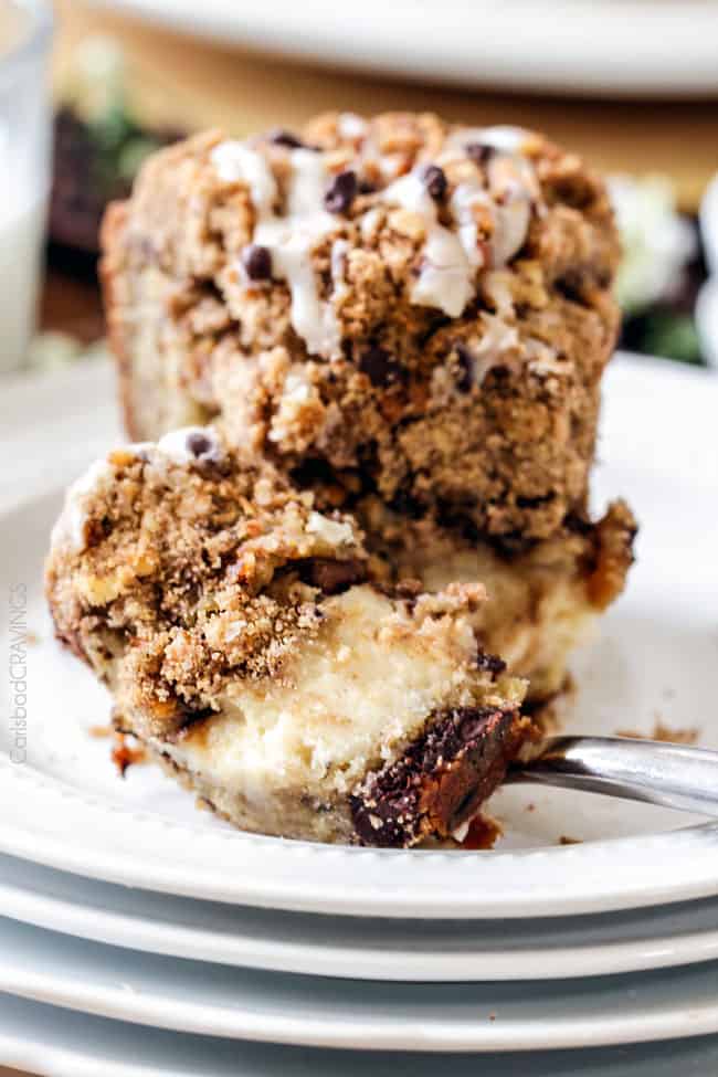 taking a bite out of sour cream coffee cake The best Banana ANYTHING ever! Moist Banana Coffee Cake riddled with chocolate chips and walnuts (optional) with an INCREDIBLY creamy cheesecake-like cream cheese filling all topped with brown sugar walnut streusel and vanilla drizzle.