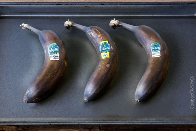 The best Banana ANYTHING ever! Moist Banana Coffee Cake riddled with chocolate chips and walnuts (optional) with an INCREDIBLY creamy cheesecake-like cream cheese filling all topped with brown sugar walnut streusel and vanilla drizzle.