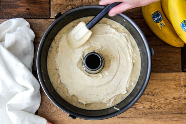The best Banana ANYTHING ever! Moist Banana Coffee Cake riddled with chocolate chips and walnuts (optional) with an INCREDIBLY creamy cheesecake-like cream cheese filling all topped with brown sugar walnut streusel and vanilla drizzle.