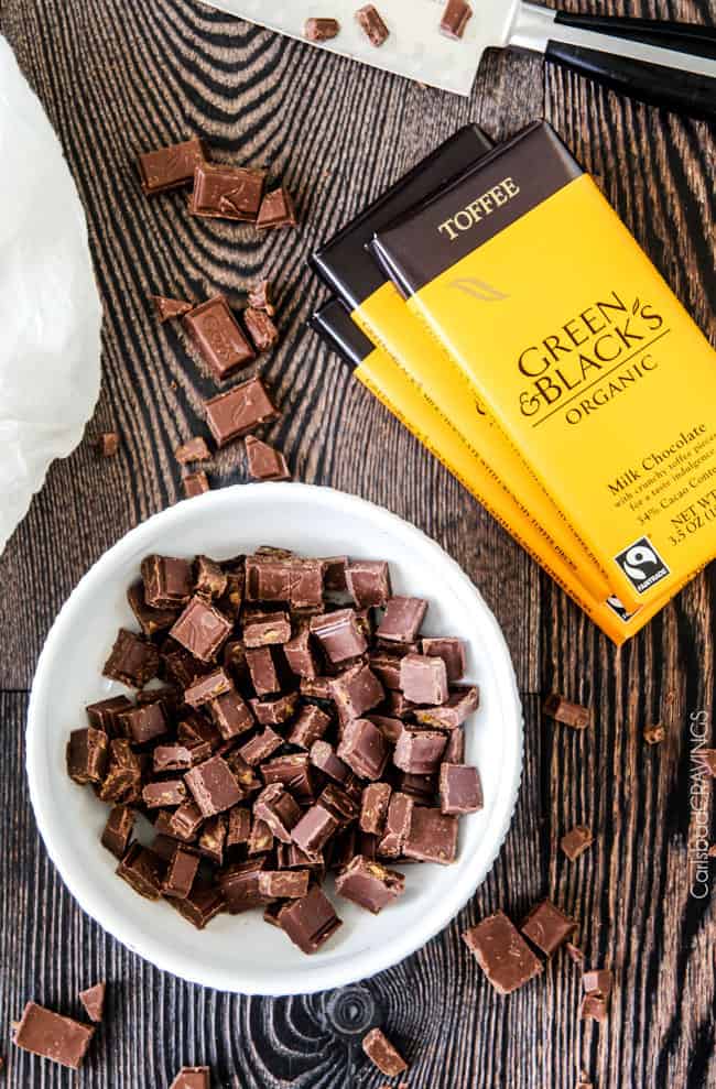 overhead view of Green & Black's Organic Milk Chocolate Toffee Bars. Some chopped up chocolate is in a white dish.