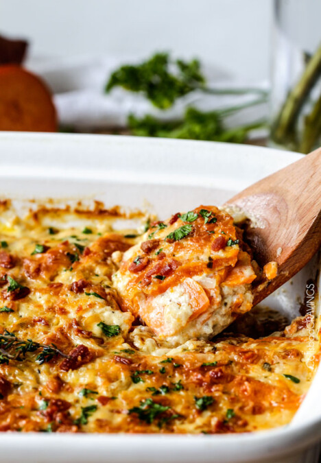 Looking for the BEST scalloped sweet potatoes ever EVER?! Fresh herbs simmered in cream poured over layers of potatoes, bacon and onions topped with Gruyere cheese. Perfect for Thanksgiving, company or every day!