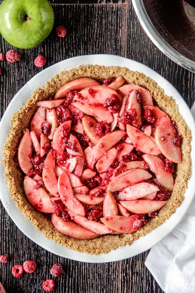 overhead view of an unbaked raspberry apple pie