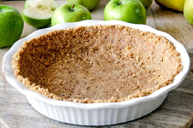 a pecan crust in a white pie plate