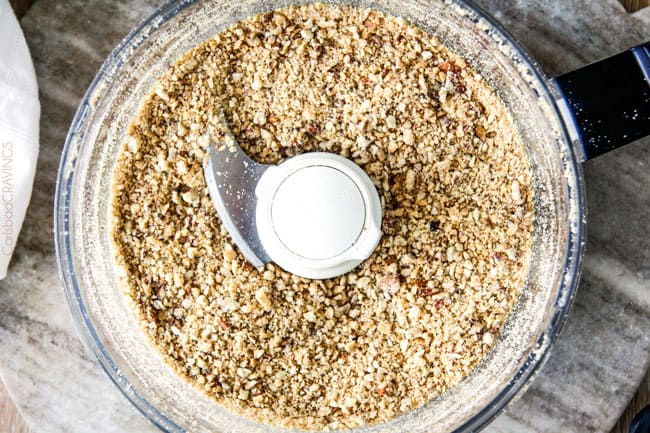 overhead view of pecan pie crust ingredients blitzed in a food processor